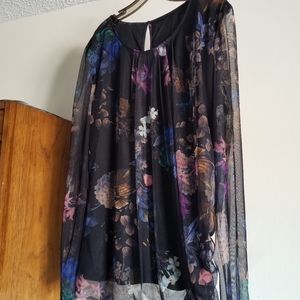 Black top with sheer floral overlay.